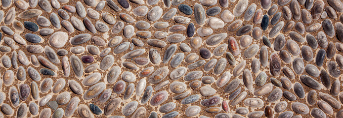 A very wide banner with the image of multicolored stones. Extra wide