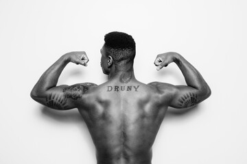 From behind powerful african american man over white background