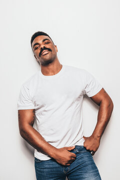 Serious Black Man With Casual Outfit Posing Over White Background