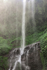 Fototapeta na wymiar Sekumpul Waterfall (Air Terjun Sekumpul in the local language) is located in the northern mountains of Bali. Also known as 'The Best Waterfall in Bali'