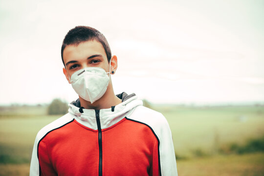 Portrait of teenager wearing protective mask outdoors