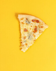 slice of pizza on a yellow background. A look from above