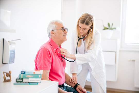 Female doctor examining senior patient in medical clinic