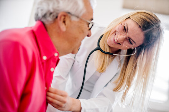 Female doctor examining senior patient in medical clinic