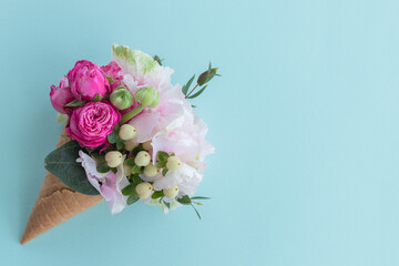 Flowers in the fafle cone. Summer concept. Flat lay space  fot text. Pastel colors background 