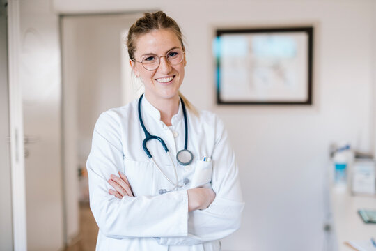Portrait of smiling female doctor with crossed arms