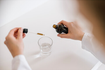 Female doctor preparing tincture
