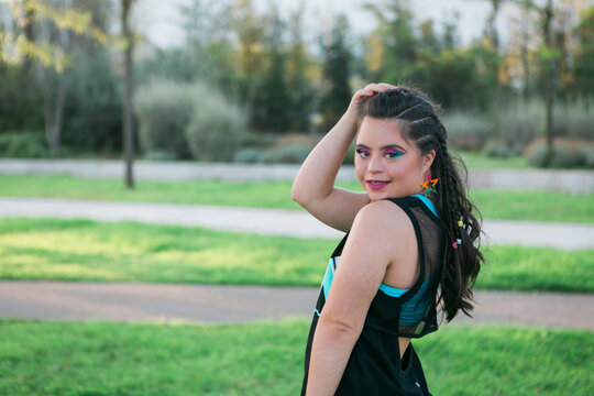Teenager girl with down syndrome wearing 80's colorful make-up and clothes