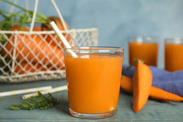 Freshly made carrot juice on wooden table