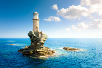 The beautiful Lighthouse Tourlitis of Chora at night. Andros island, Cyclades, Greece