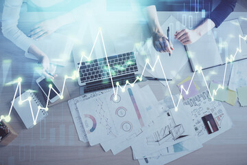 Double exposure of woman hands working on computer and forex graph hologram drawing. Top View....