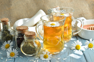 Healing herbs and healthy tea on a wooden table