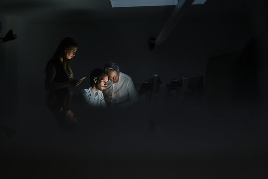 Team of business people working late in office, disussing solutions