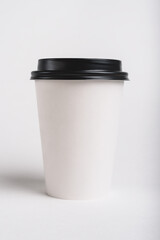 Eco friendly white paper cup for coffee to go with black lid on the white background. Zero waste, plastic free concept. Sustainable lifestyle. Front view.