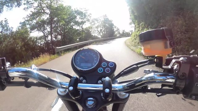 Riding an old black motorbike on a curly asphalt tarmac road driver point of view time lapse