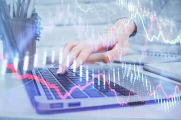 Multi exposure of woman hands typing on computer and forex chart hologram drawing. Stock market analysis concept.