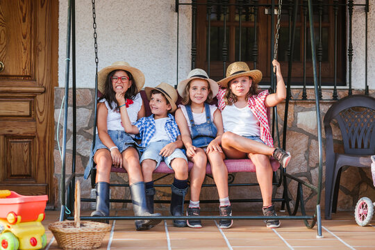 Group of children sitting on canopy swing
