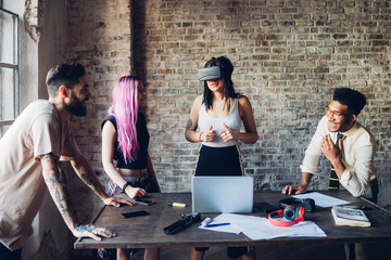 Creative team using Vr goggles in loft office