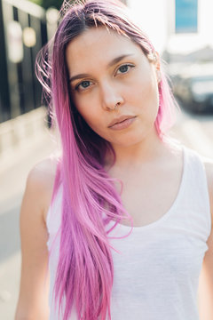 Portrait of a stylish young woman with pink hair