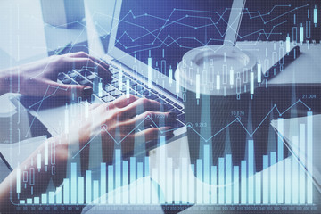 Double exposure of woman hands typing on computer and forex chart hologram drawing. Stock market invest concept.