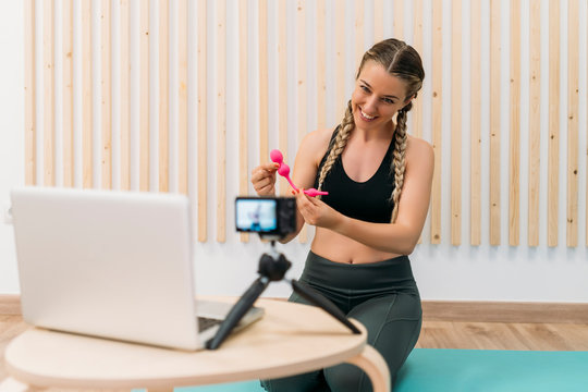 Sporty Woman Filming Herself With Camera And Laptop Introducing A Product