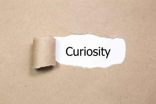 curiosity word under torn paper