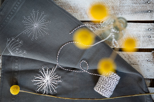 Embroidered fabric and bottleÔøΩwith blooming billy buttons