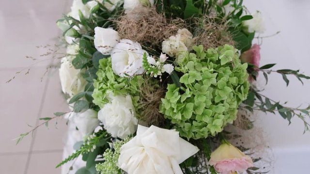 Decorating a Festive table. Wedding Table Decoration with Bouquets of Natural Fresh Flowers for a Family Feast, Wedding decor, pastel flowers in garden ceremony on green background