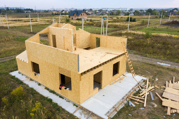 Construction of new and modern modular house. Walls made from composite wooden sip panels with...