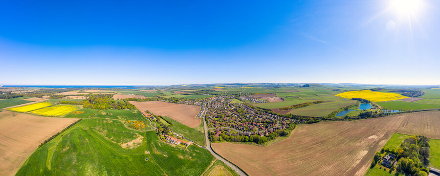 UK, Scotland, East Linton, Aerial Panorama Of Sun Shining Over Countryside Town In Summer