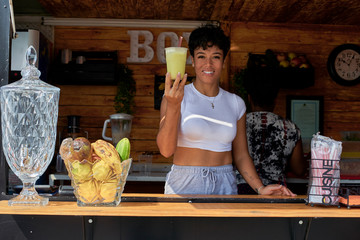 Woman in a food truck offering cup of lemonade