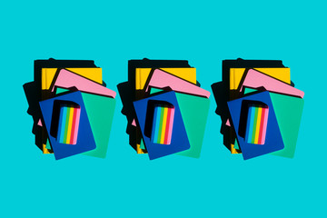 Row of stacks of notebooks and rainbow colored erasers