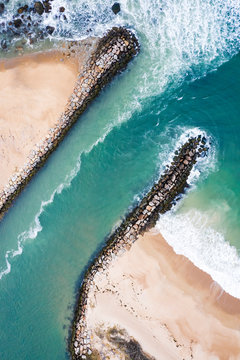 Aerial view of a jetty and beach in New England