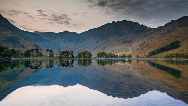 Dawn around Buttermere, the lake in the English Lake District in North West England. The adjacent village of Buttermere takes its name from the lake.