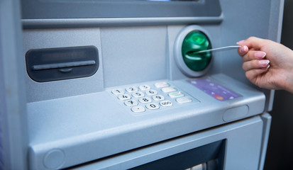 hand entering card on ATM/bank machine