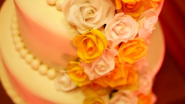 light music flashes on edible roses from sweet mastic on a birthday cake on the party