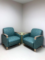 Two patterned lounge chairs placed in corner of hospital facility