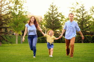 Happy family walk in the park in summer