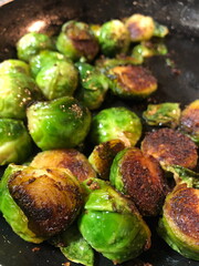 Sautéed garlic brussel sprouts in cast iron pan 