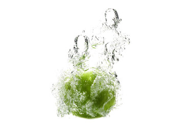 one green apple falling into water on a white background with splashes, drops and bubbles.