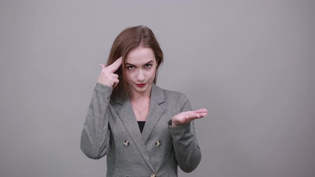 Forefingers temples. Playing the fool. Out of mind, displeased with reckless silly joke. Crazy, making stupid sign finger near head, gesturing bad think, dumb insane idea, dissatisfied senseless talk