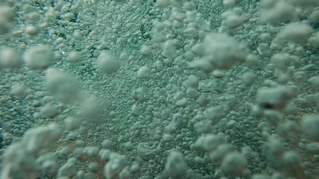 Bubble emerging into surface. Lake bubbles in slow-motion