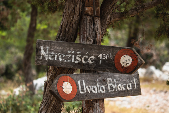 Wooden signpost showing the way to the Pustinja Blaca, desert area of the island of brac in croatia
