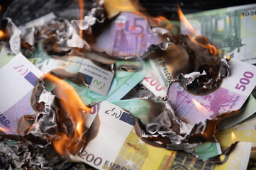 burning euro bills for financial crisis background