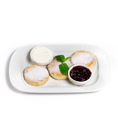 Russian Syrniki, with red currant berries, blueberries