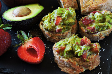 Guacamole toast with strawberries. Healthy snack. Strawberry guacamole.