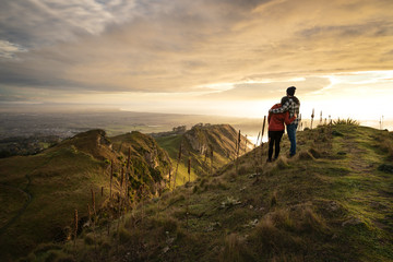 Fototapeta premium Couple embracing each other on the peak on a mountain