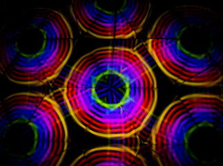 3D rendering or 3D rendering. Kaleidoscopic image. Symmetry with colored lights on a black background.