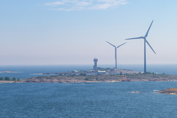 Windmill on an island in the sea. wind generator for generating electricity. renewable energy...