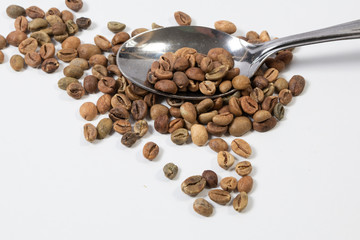 Organic green coffee beans isolated on white background close up. Top view. Flat lay